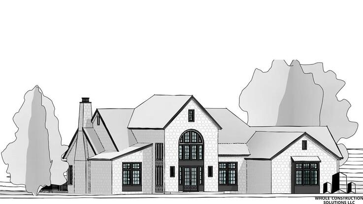 Front elevation of a traditional-style stone home with arched windows, gabled rooflines, and a central chimney designed by Whole Construction Solutions LLC.